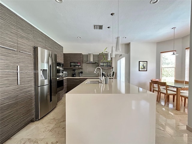 3968 Nighthawk Dr, Weston, FL 33331 - kitchen featuring stainless steel appliances, modern cabinets, a sink, wall chimney exhaust hood, and light countertops
