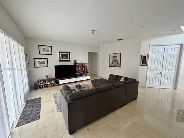 3968 Nighthawk Dr, Weston, FL 33331 - living area with light marble finish flooring and healthy amount of natural light
