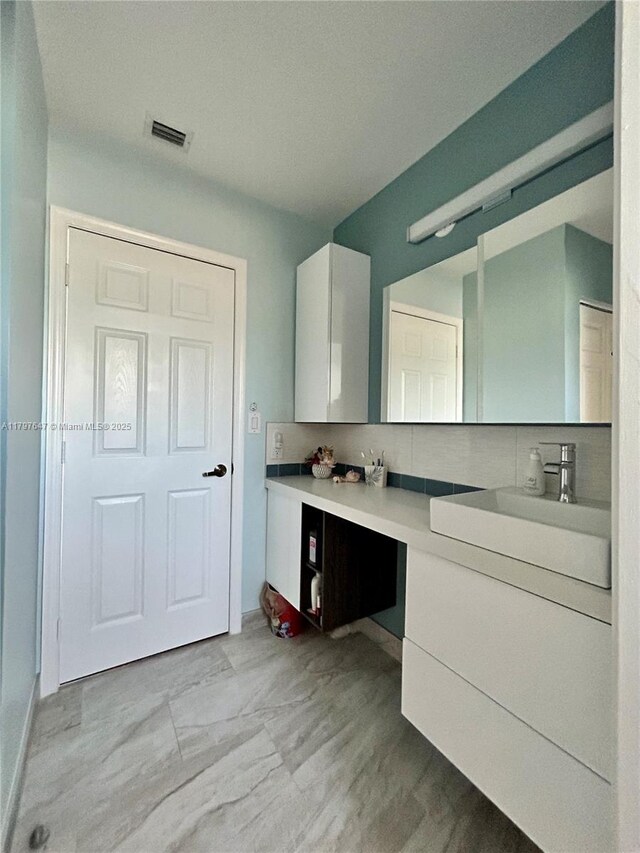 3968 Nighthawk Dr, Weston, FL 33331 - bathroom featuring vanity, backsplash, and baseboards