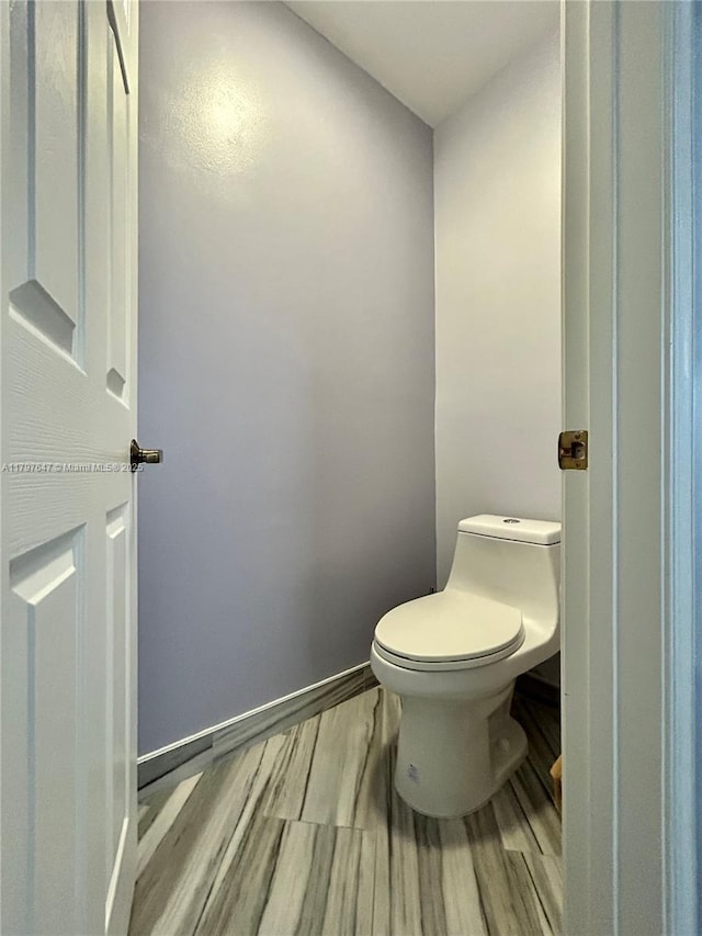 3968 Nighthawk Dr, Weston, FL 33331 - bathroom featuring toilet, wood finished floors, and baseboards