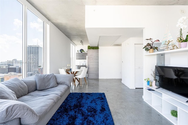 151 SE 1st St Unit 1610, Miami, FL 33131 - living room featuring finished concrete flooring, baseboards, and a view of city