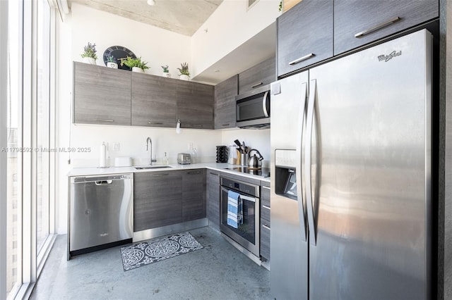 151 SE 1st St Unit 1610, Miami, FL 33131 - kitchen with stainless steel appliances, a sink, concrete flooring, modern cabinets, and light countertops