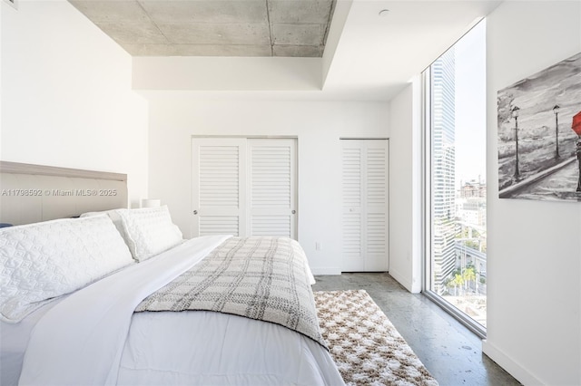 151 SE 1st St Unit 1610, Miami, FL 33131 - bedroom with access to exterior, two closets, and baseboards