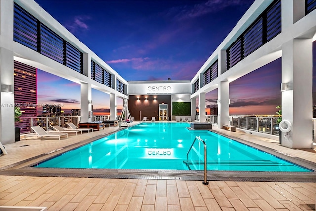 151 SE 1st St Unit 1610, Miami, FL 33131 - pool at dusk featuring a community pool and a deck
