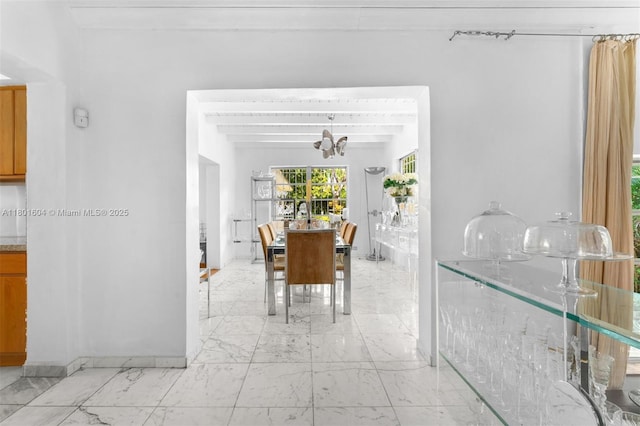 650 NE 60th St, Miami, FL 33137 - dining area featuring light marble finish flooring and a chandelier