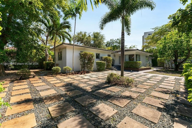650 NE 60th St, Miami, FL 33137 - view of front of property with stucco siding and a patio area