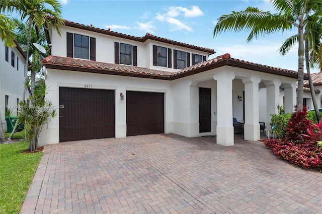 2691 NW 83rd Ter, Cooper City, FL 33024 - mediterranean / spanish home featuring stucco siding, decorative driveway, and a garage