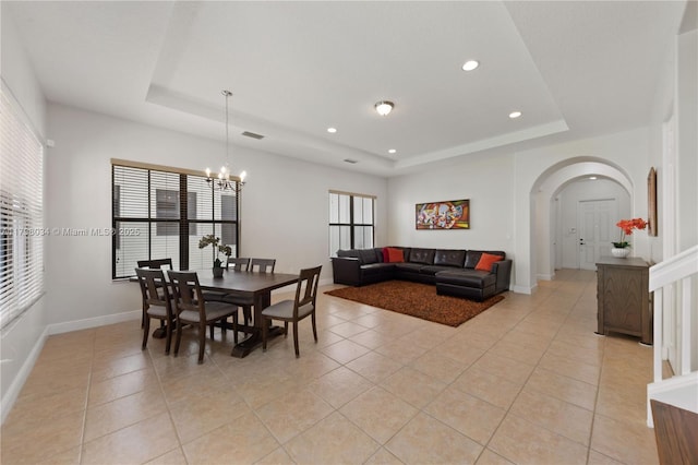 2691 NW 83rd Ter, Cooper City, FL 33024 - dining room featuring a tray ceiling, arched walkways, light tile patterned floors, and recessed lighting