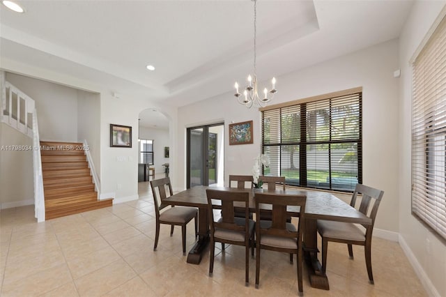 2691 NW 83rd Ter, Cooper City, FL 33024 - dining area featuring stairs, arched walkways, a raised ceiling, light tile patterned floors, and a chandelier