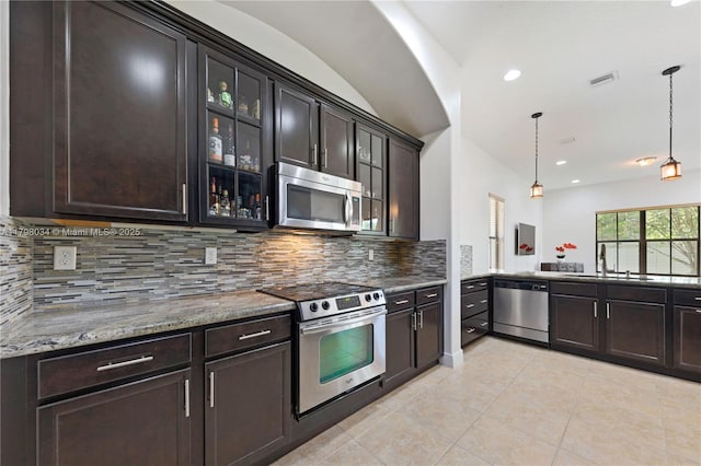 2691 NW 83rd Ter, Cooper City, FL 33024 - kitchen featuring stainless steel appliances, a sink, light tile patterned floors, decorative backsplash, and recessed lighting