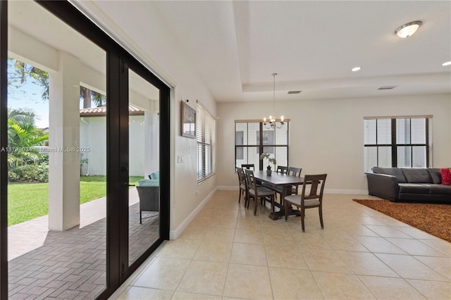 2691 NW 83rd Ter, Cooper City, FL 33024 - dining area with healthy amount of natural light, a chandelier, baseboards, a tray ceiling, and recessed lighting