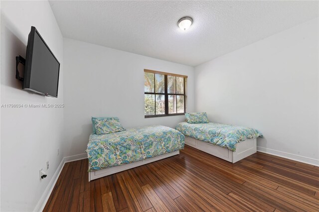 2691 NW 83rd Ter, Cooper City, FL 33024 - bedroom featuring baseboards, wood finished floors, and a textured ceiling
