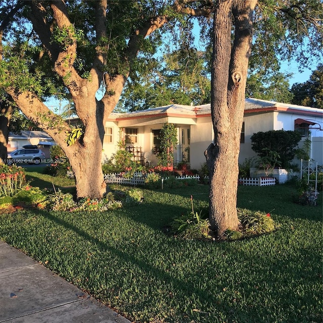 327 SE 2nd Ave, Dania Beach, FL 33004 - view of front of home with a front lawn and stucco siding