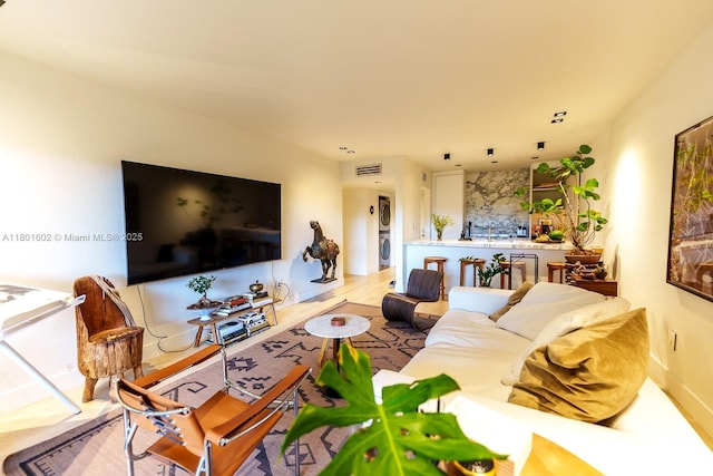 living room featuring stacked washer / dryer
