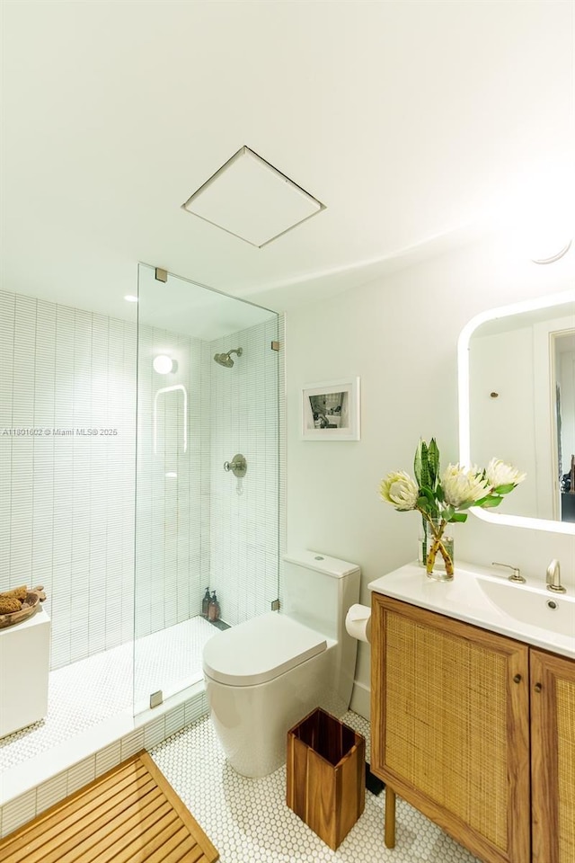 bathroom with toilet, a stall shower, vanity, and tile patterned flooring