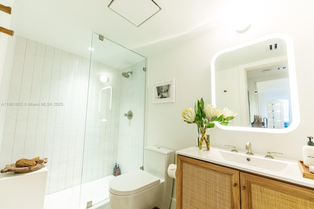 bathroom featuring toilet, a shower stall, and vanity