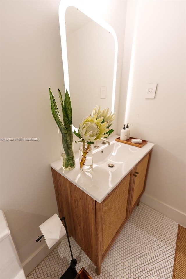 bathroom with vanity and baseboards