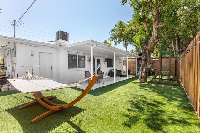 2340 SW 17th Ave, Miami, FL 33145 - rear view of property featuring a patio area, stucco siding, and central AC unit