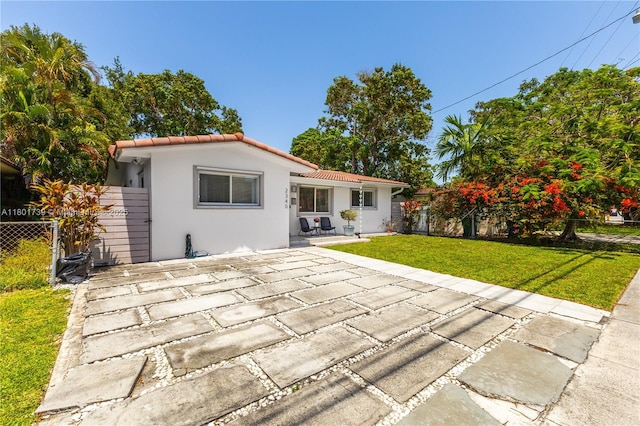 2340 SW 17th Ave, Miami, FL 33145 - back of house featuring stucco siding, a tiled roof, and a patio area