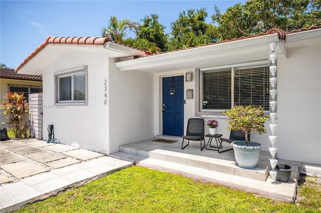 2340 SW 17th Ave, Miami, FL 33145 - property entrance with a tiled roof, stucco siding, and covered porch