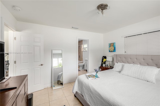 2340 SW 17th Ave, Miami, FL 33145 - bedroom with light tile patterned flooring, ensuite bath, and baseboards