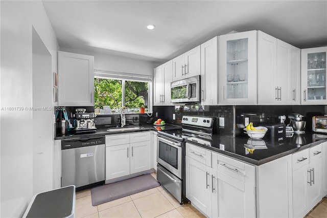 2340 SW 17th Ave, Miami, FL 33145 - kitchen with appliances with stainless steel finishes, a sink, dark countertops, white cabinets, and recessed lighting