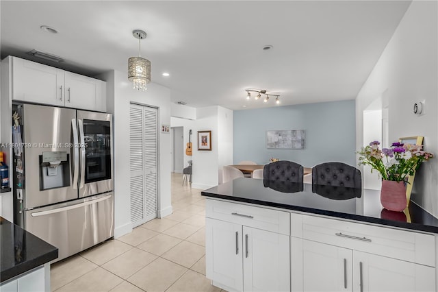 2340 SW 17th Ave, Miami, FL 33145 - kitchen featuring stainless steel fridge, dark countertops, light tile patterned floors, white cabinetry, and pendant lighting