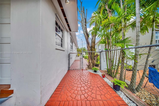 view of patio featuring a gate and fence