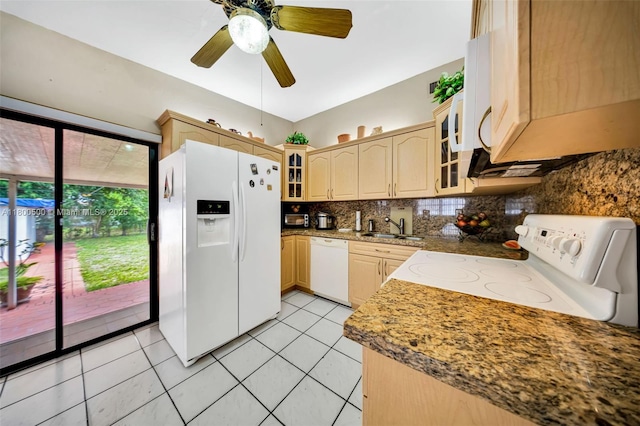 kitchen featuring white appliances, a sink, tasteful backsplash, glass insert cabinets, and light tile patterned floors