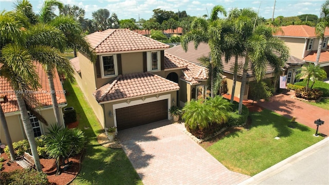 4940 Gateway Gardens Dr, Boynton Beach, FL 33436 - mediterranean / spanish-style home featuring a tile roof, decorative driveway, a garage, and stucco siding