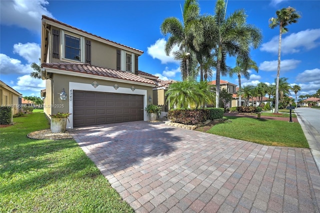 4940 Gateway Gardens Dr, Boynton Beach, FL 33436 - mediterranean / spanish house featuring stucco siding, a tiled roof, a front lawn, and decorative driveway