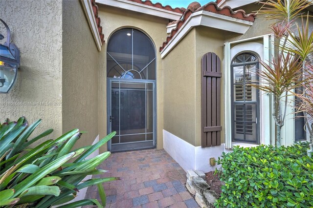 4940 Gateway Gardens Dr, Boynton Beach, FL 33436 - view of exterior entry with stucco siding and a tile roof