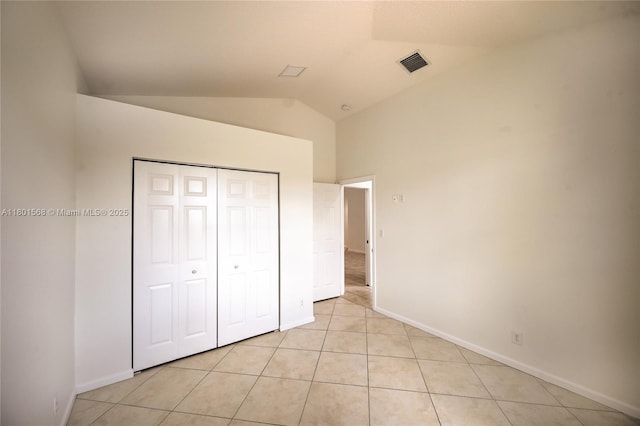 4940 Gateway Gardens Dr, Boynton Beach, FL 33436 - unfurnished bedroom featuring lofted ceiling, baseboards, light tile patterned floors, and a closet