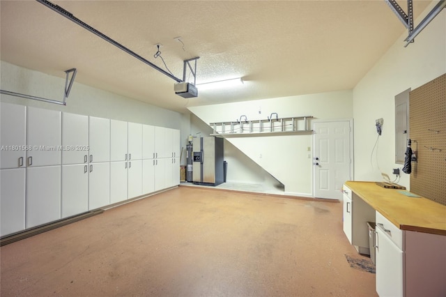 4940 Gateway Gardens Dr, Boynton Beach, FL 33436 - garage featuring a garage door opener and refrigerator with ice dispenser