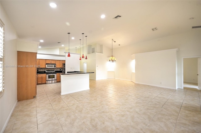 4940 Gateway Gardens Dr, Boynton Beach, FL 33436 - kitchen with appliances with stainless steel finishes, dark countertops, open floor plan, brown cabinetry, and recessed lighting