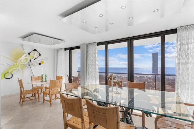 19667 Turnberry Way Unit 27-K, Aventura, FL 33180 - dining room featuring a water view, recessed lighting, a raised ceiling, and floor to ceiling windows