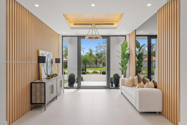 doorway featuring expansive windows, a raised ceiling, and recessed lighting
