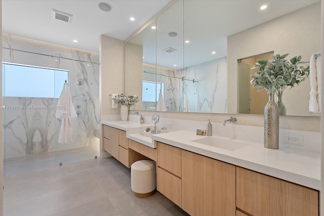 full bath with a marble finish shower, vanity, recessed lighting, and concrete flooring
