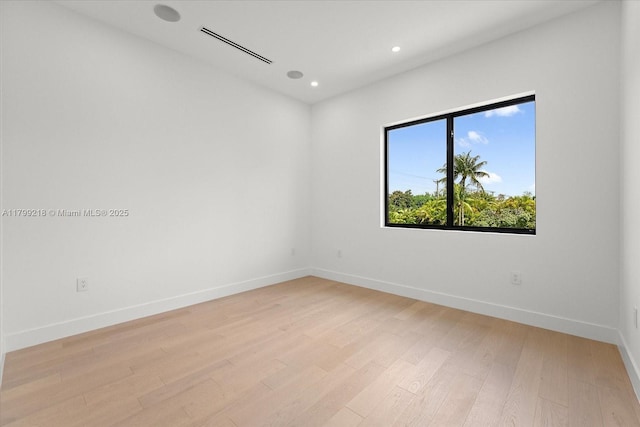 unfurnished room with light wood-style floors, recessed lighting, and baseboards