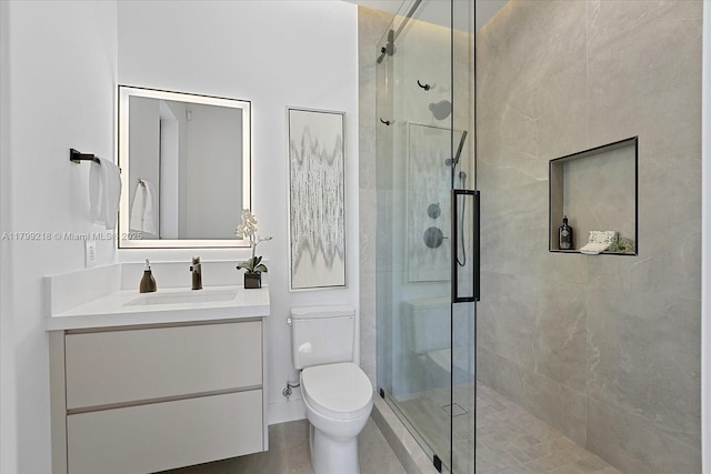 full bathroom with a shower stall, toilet, and vanity