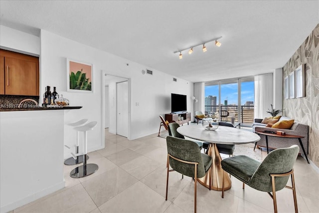 dining area featuring baseboards and light tile patterned flooring