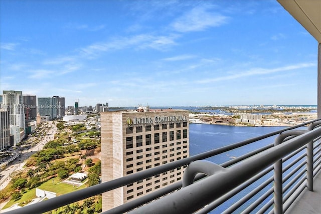 balcony featuring a city view and a water view