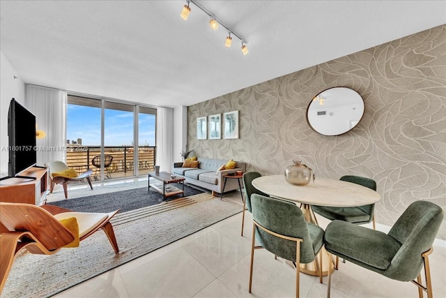 living room featuring wallpapered walls and rail lighting
