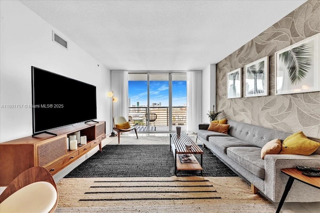living room with expansive windows and an accent wall