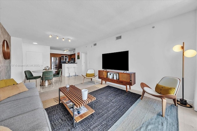 living area with a textured ceiling