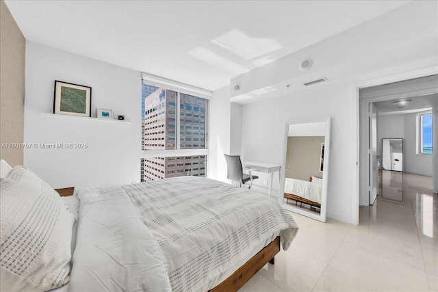 bedroom with light tile patterned floors