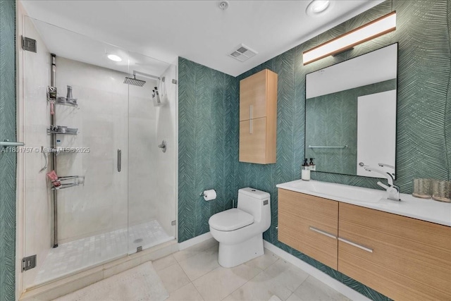 full bath with toilet, a stall shower, tile patterned floors, and vanity