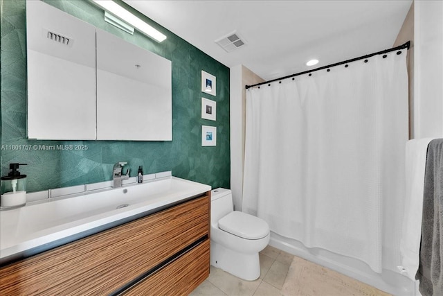 bathroom featuring toilet, tile patterned flooring, and vanity