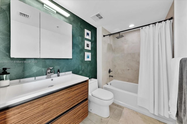 full bathroom featuring tile patterned floors, toilet, shower / bath combo with shower curtain, and vanity