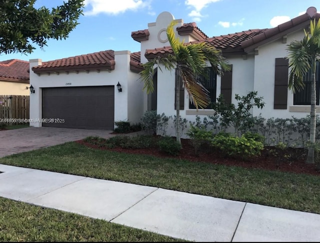 15400 SW 176th Ln, Miami, FL 33187 - mediterranean / spanish-style home featuring a garage, stucco siding, a tiled roof, and driveway